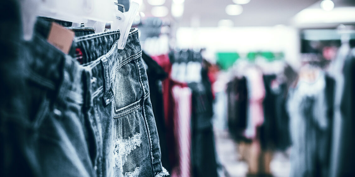 a pair of jeans on a hanger in a clothes store