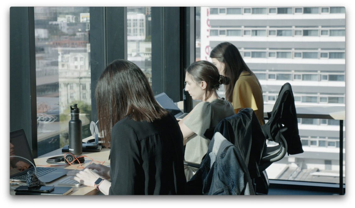 women working in an office on laptops
