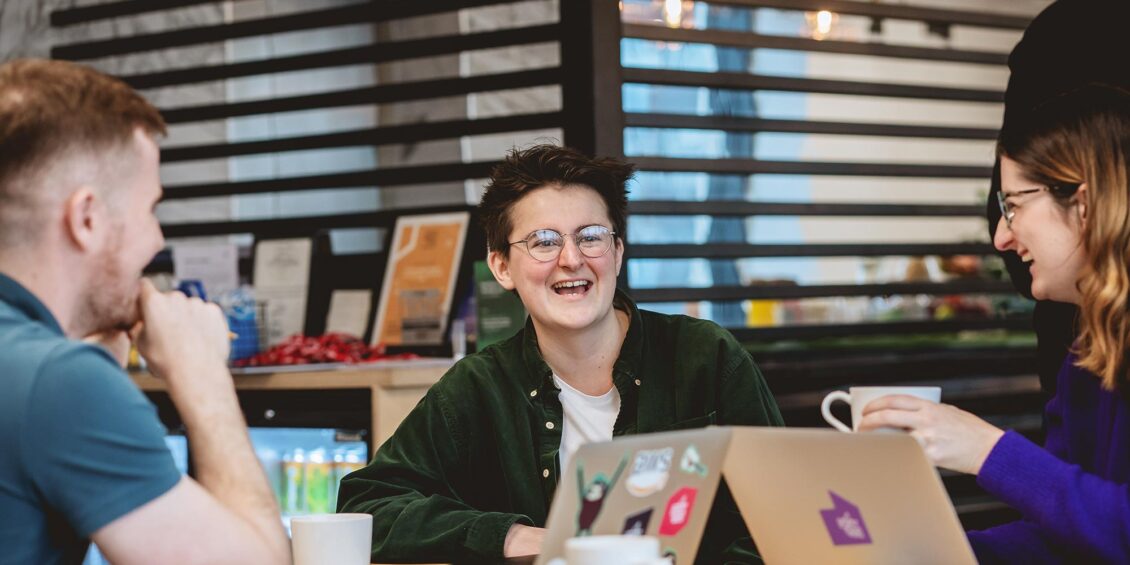 three happy data scientists in an office
