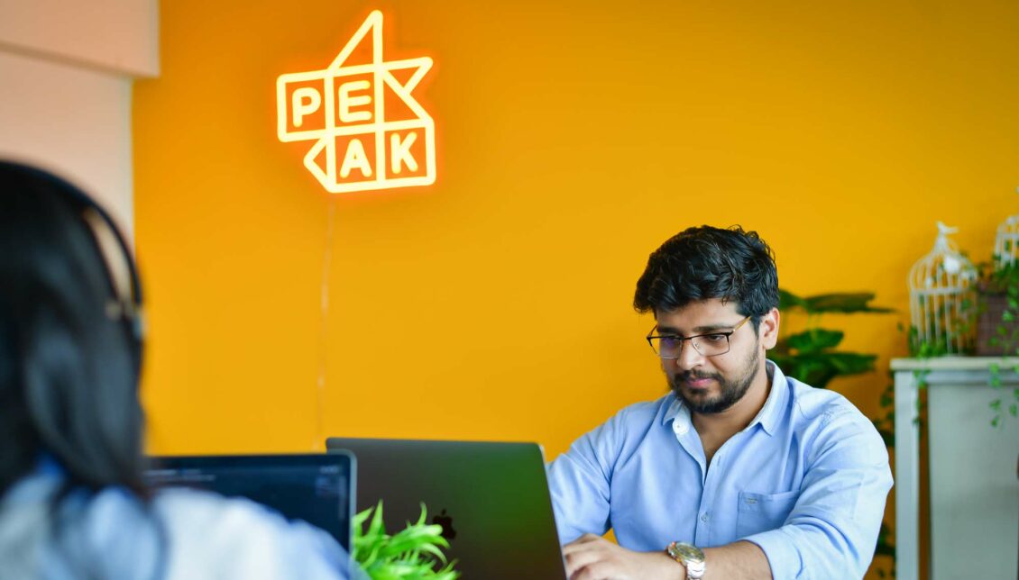 man working on a laptop in an office in india