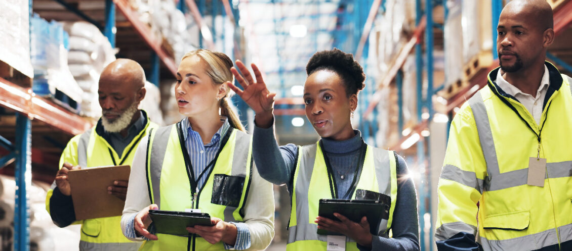 supply chain managers in a warehouse wearing hi vis jackets