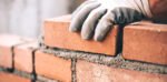 a bricklayer building a wall